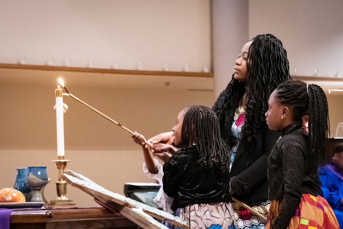 March 31, 2019:  During Lent, the Ahlijah family assists with the start of the Worship service by lighting the candles on the Communion table.